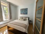Second bedroom with a queen bed — Cozy Heritage 2BR with Lush Private Garden Patio