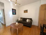 Comfortable living room with classic Plateau character — Cozy Heritage 2BR with Lush Private Garden Patio