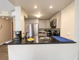 Open kitchen with coffee maker and kettle — Bright 2BR Retreat