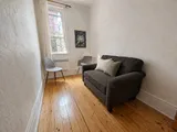 Library detail with books and heritage character — Cozy Heritage 2BR with Lush Private Garden Patio