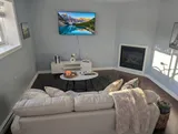 Living room with sofa and television — Modern 1BR with Desk Near YUL