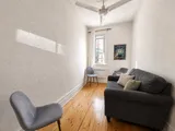 Library and reading area with built-in bookshelves — Cozy Heritage 2BR with Lush Private Garden Patio
