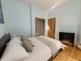 Second bedroom with soft lighting and classic details — Cozy Heritage 2BR with Lush Private Garden Patio