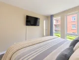 First bedroom windows overlooking the courtyard — Bright 2BR Retreat