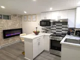 Kitchen with stove and refrigerator — Stylish Modern 1BR with EV Charger