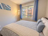 Second bedroom queen bed and television — Bright 2BR Retreat