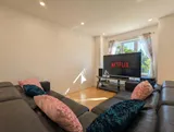 Living room with sofa and television — Spacious 2BR Holiday Home Near YUL