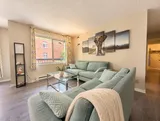 First bedroom television and storage — Bright 2BR Retreat