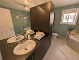 Bathroom with bathtub and vanity — Modern 1BR with Desk Near YUL