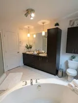 Bathroom with corner bathtub — Modern 1BR with Private Bath