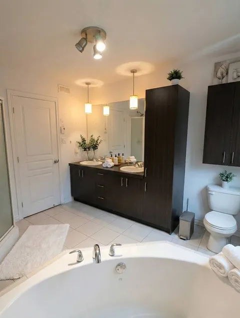 Bathroom with corner bathtub — Modern 1BR with Private Bath