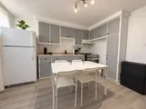 Kitchen with refrigerator, stove and dining table for four — Cozy 2-Bedroom Retreat