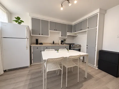 Kitchen with refrigerator, stove and dining table for four — Cozy 2-Bedroom Retreat