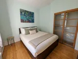 Second queen bedroom interior — Cozy Heritage 2BR with Lush Private Garden Patio