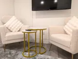 TV seating area with armchairs — Stylish Modern 1BR with EV Charger