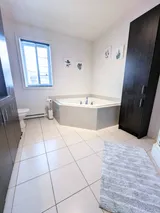 Bathroom with corner bathtub — Modern 1BR with Private Bath