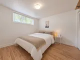 First queen bedroom beside the window — Cozy 2-Bedroom Retreat