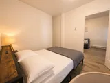 Bedroom with bed and bedside lighting — Cozy Luxury in the Plateau