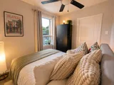 Bedroom with bed and bedside lighting — Luxury 2BR in the Plateau