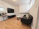 Living room with large mirror and comfortable sofa — Cozy 2-Bedroom Retreat