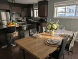Dining table and chairs — Modern 1BR with Desk Near YUL