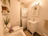 Bathroom with sink and stacked laundry appliances — Cozy Luxury in the Plateau