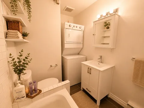 Bathroom with sink and stacked laundry appliances — Cozy Luxury in the Plateau