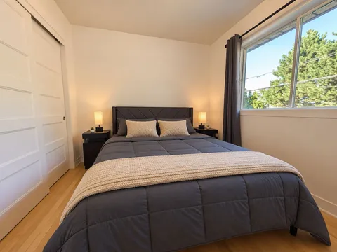 Third queen bedroom with large window — Modern 3BR Spacious Home