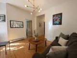 Living room detail with thoughtfully styled furnishings — Cozy Heritage 2BR with Lush Private Garden Patio