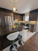 Kitchen island and counter seating — Modern 1BR with Private Bath