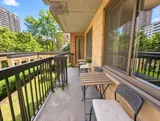Private furnished balcony with outdoor seating — Bright 2BR Retreat