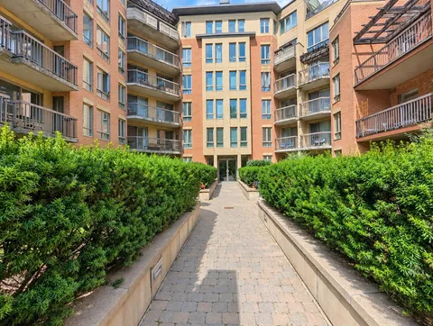 Landscaped shared courtyard and apartment building — Bright 2BR Retreat