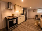 Kitchen with stove and refrigerator — Cozy 1BR in Saint-Constant