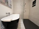 Full bathroom with bathtub and shower — Cozy Heritage 2BR with Lush Private Garden Patio