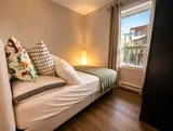Bedroom with bed and bedside lighting — Luxury 2BR in the Plateau