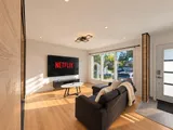 Living room and front entrance in afternoon light — Modern 3BR Spacious Home