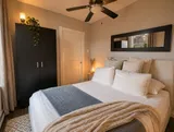 Bedroom with bed and bedside lighting — Luxury 2BR in the Plateau
