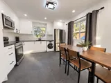 Full kitchen with appliances and dining table — Modern 3BR Spacious Home