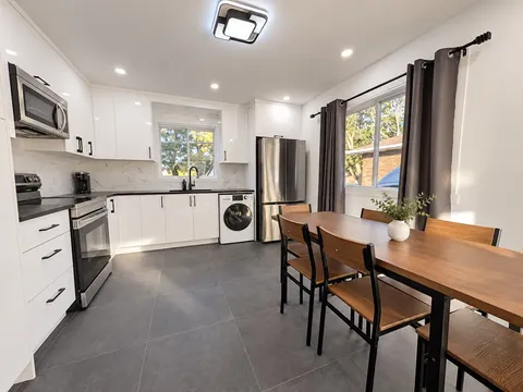 Full kitchen with appliances and dining table — Modern 3BR Spacious Home