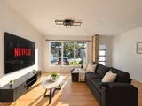 Living room seating facing the television — Modern 3BR Spacious Home