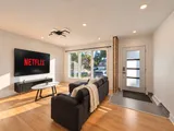 Living room television and seating beside the entrance — Modern 3BR Spacious Home