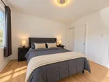 First queen bedroom facing the window — Modern 3BR Spacious Home