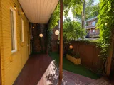Private garden patio with grill and seating — Cozy Heritage 2BR with Lush Private Garden Patio
