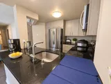 Kitchen counter with sink and full-size appliances — Bright 2BR Retreat
