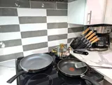Stovetop with cookware — Stylish Modern 1BR with EV Charger