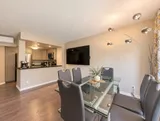 Dining room with six chairs and HDTV — Bright 2BR Retreat
