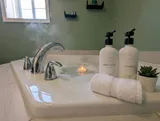 Bathroom sink and toiletries — Modern 1BR with Desk Near YUL