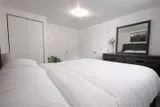 Bedroom with dresser and wardrobe — Rehoboth 1BR in Laval