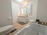 Bathroom with bathtub and vanity — Spacious 2BR Holiday Home Near YUL