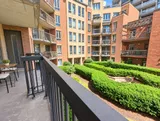 Private balcony overlooking the landscaped courtyard — Bright 2BR Retreat